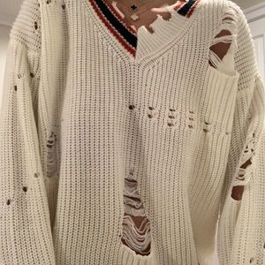 Distressed white sweater.